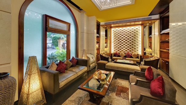 A spacious living area with a sofa set, a coffee table, and a chandelier.