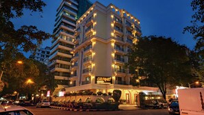 A multi-story hotel with illuminated balconies and a prominent 'Grand' sign.
