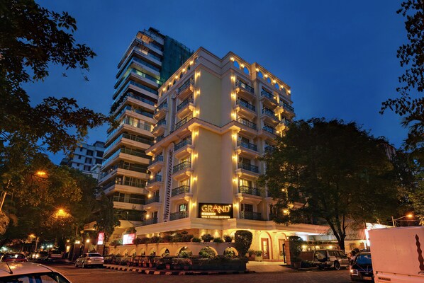 A multi-story hotel with illuminated balconies and a prominent 'Grand' sign.