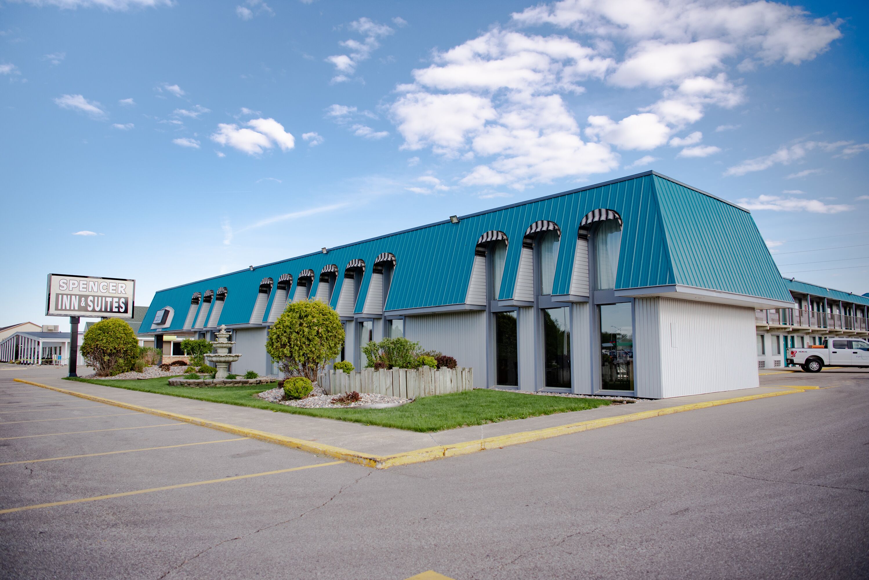 A hotel with a blue exterior and multiple windows.