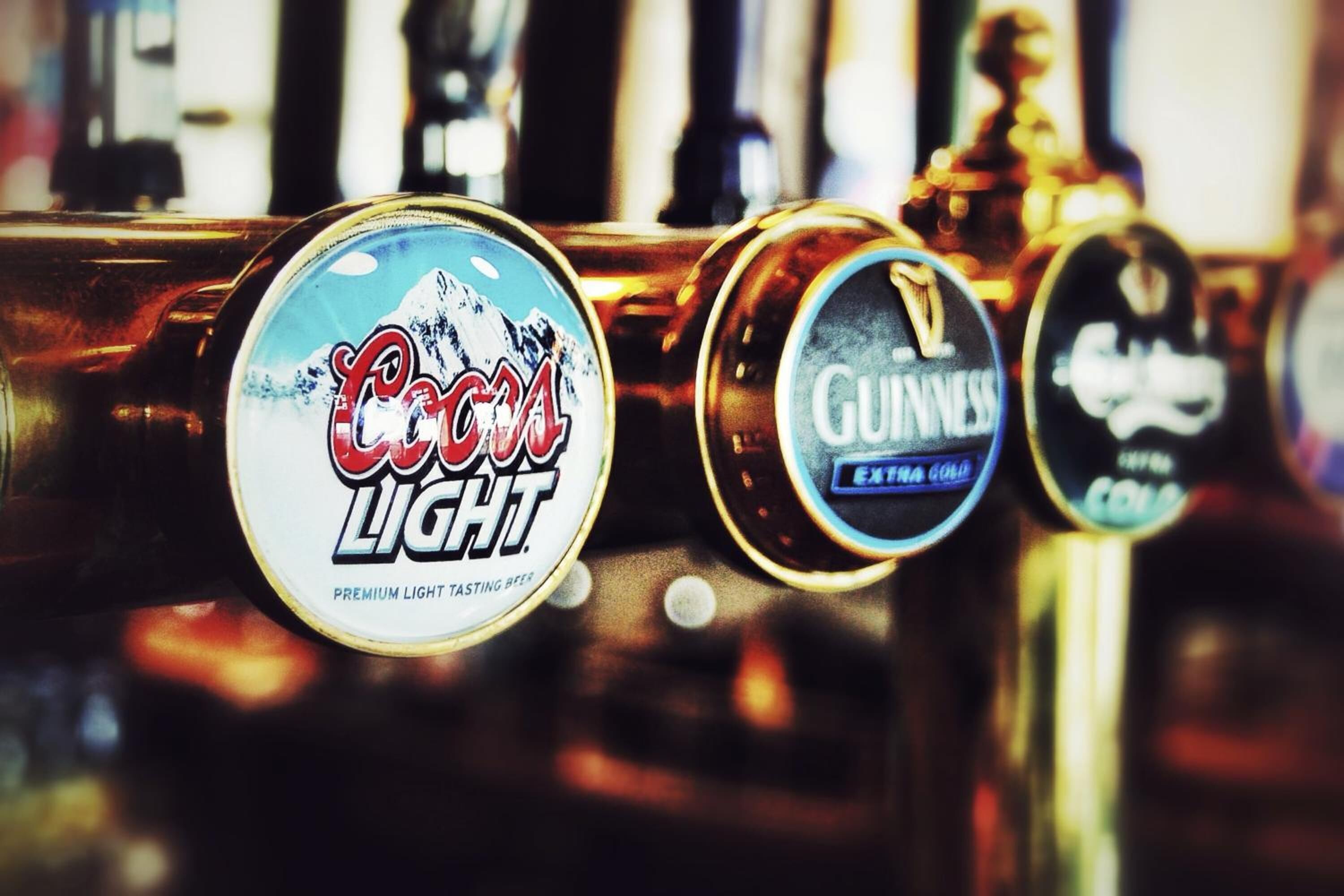 A bar with beer taps labeled 'Coors Light' and 'Guinness'.