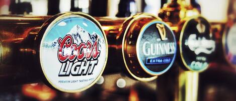 A bar with beer taps labeled 'Coors Light' and 'Guinness'.