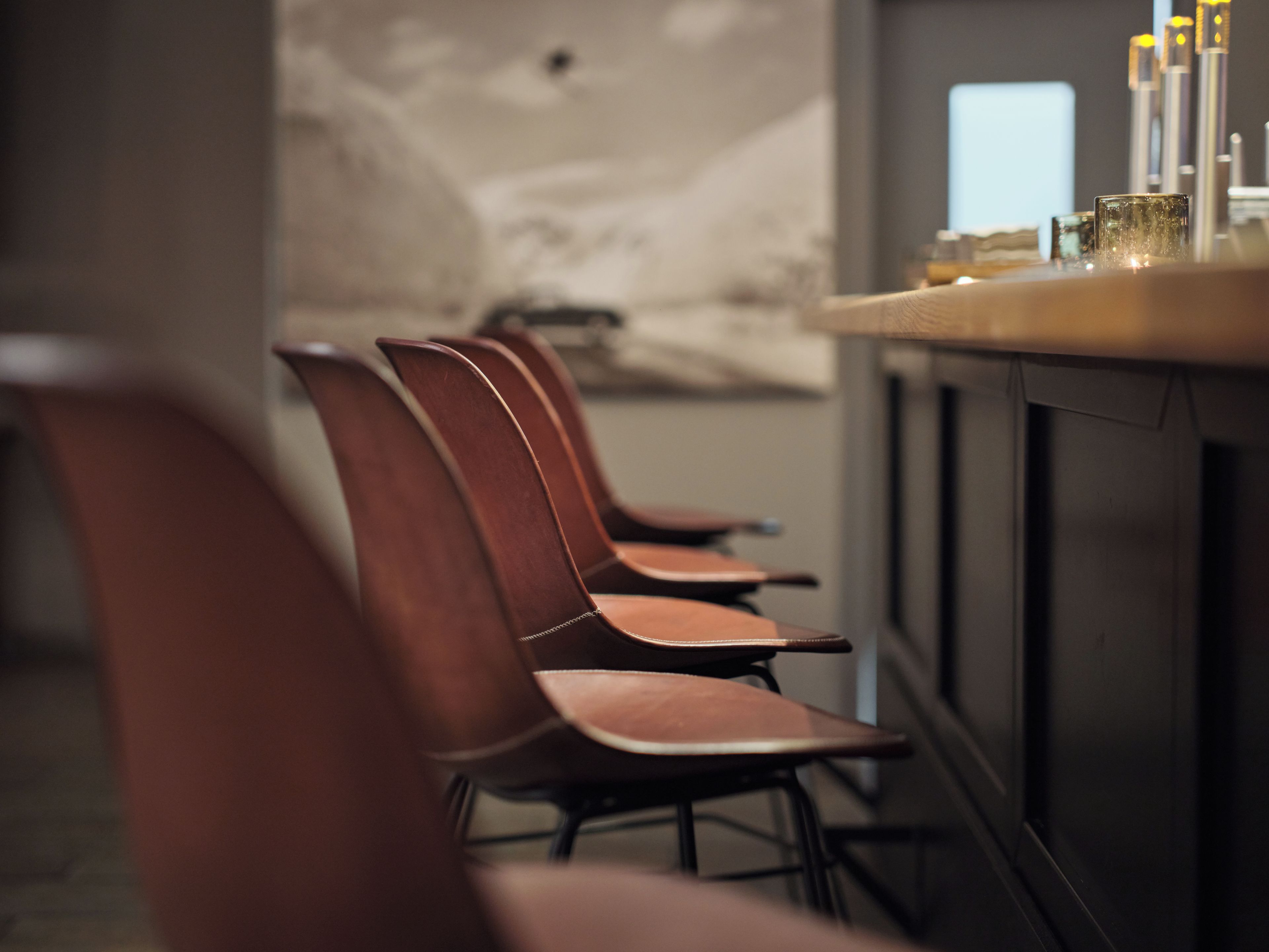 A row of chairs with a bar area in the background.
