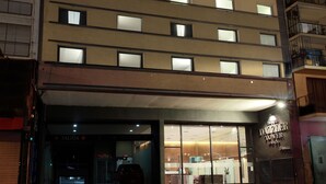 A hotel entrance with a sign for 'Hotel Dazzler Tower' and a visible entrance door. - Dazzler by Wyndham Buenos Aires Maipu (Buenos Aires)