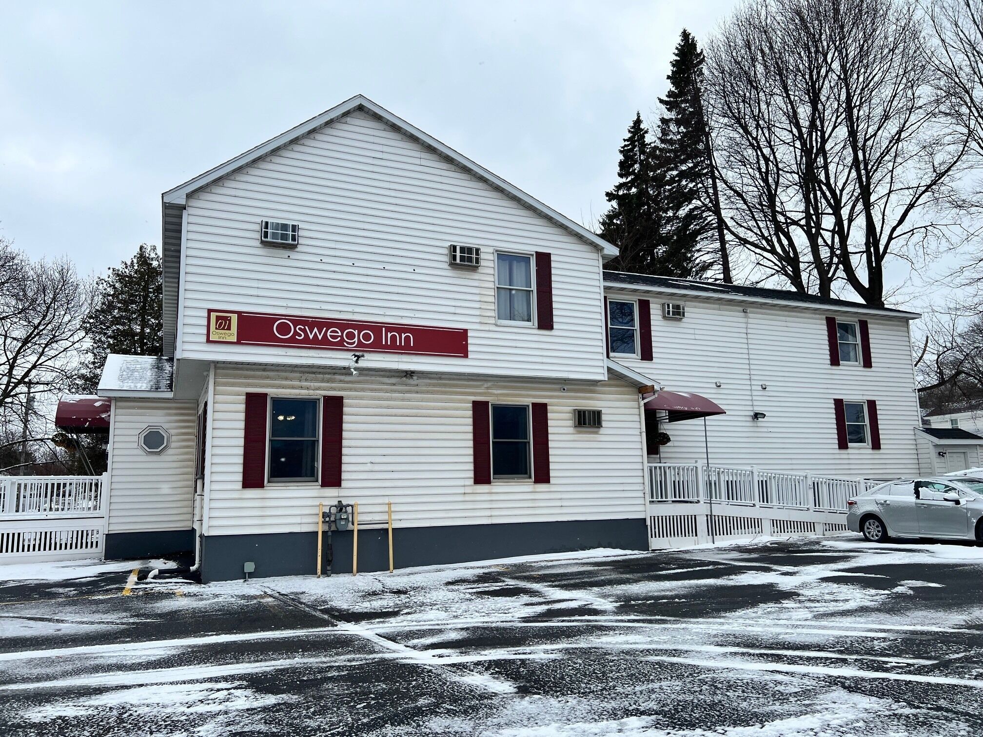 A two-story building with a sign reading 'Oswego Inn.'