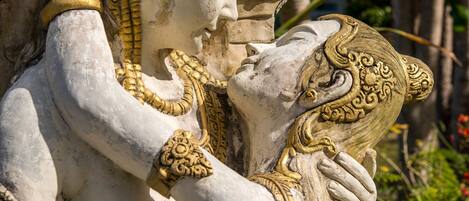 A statue of a deity with intricate carvings and a golden headdress.