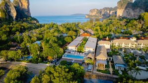 A resort with multiple buildings, a swimming pool, and a view of the ocean and cliffs. - Railay Princess Resort & Spa (Krabi)