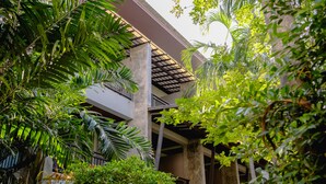 A building with a covered outdoor area, surrounded by lush greenery. - Railay Princess Resort & Spa (Krabi)
