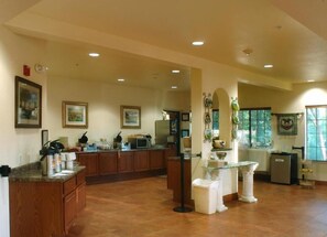 A spacious kitchen with wooden cabinets, a microwave, and a glass-top island.