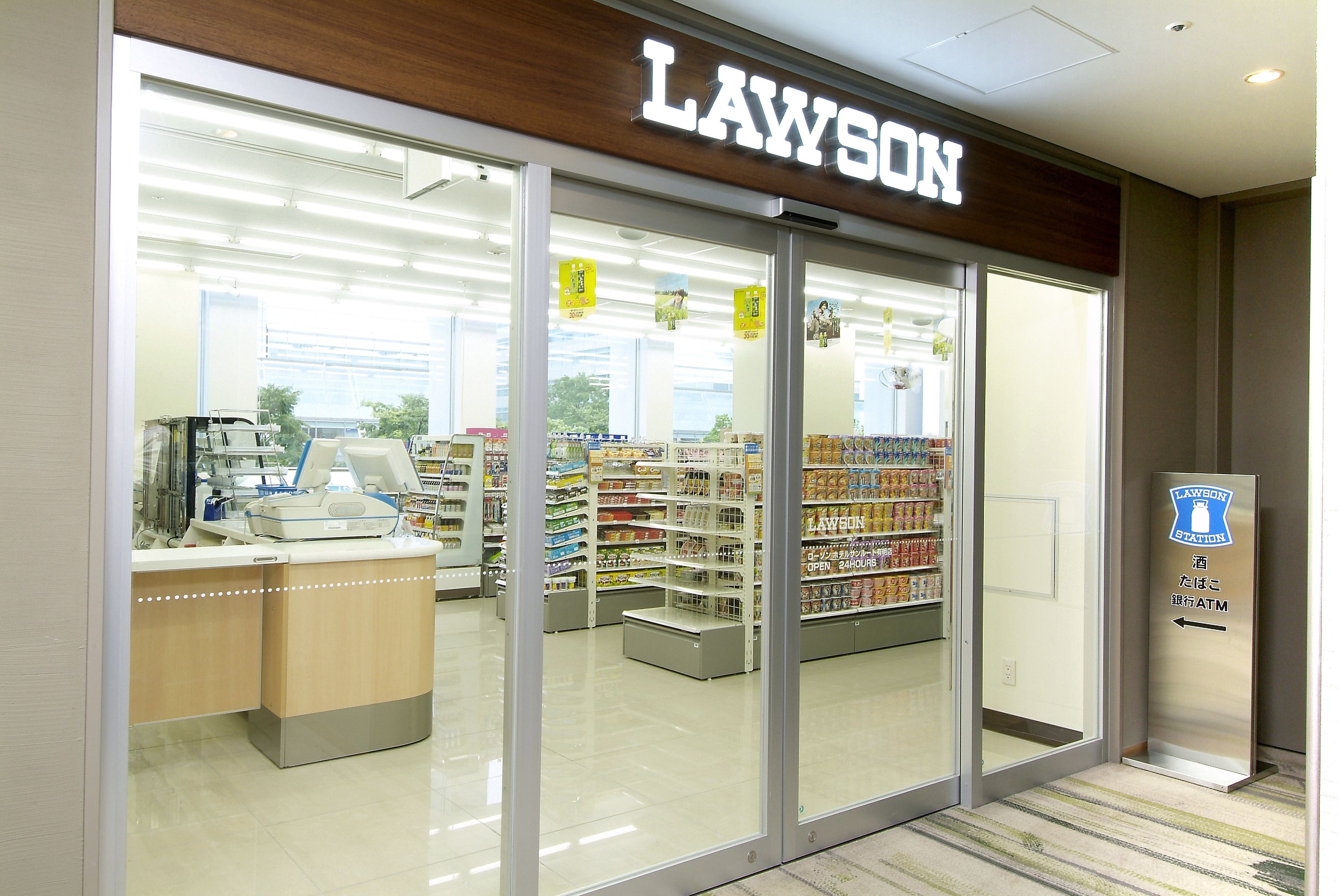 A Lawson store with a clear entrance, a visible ATM, and a variety of products on shelves.