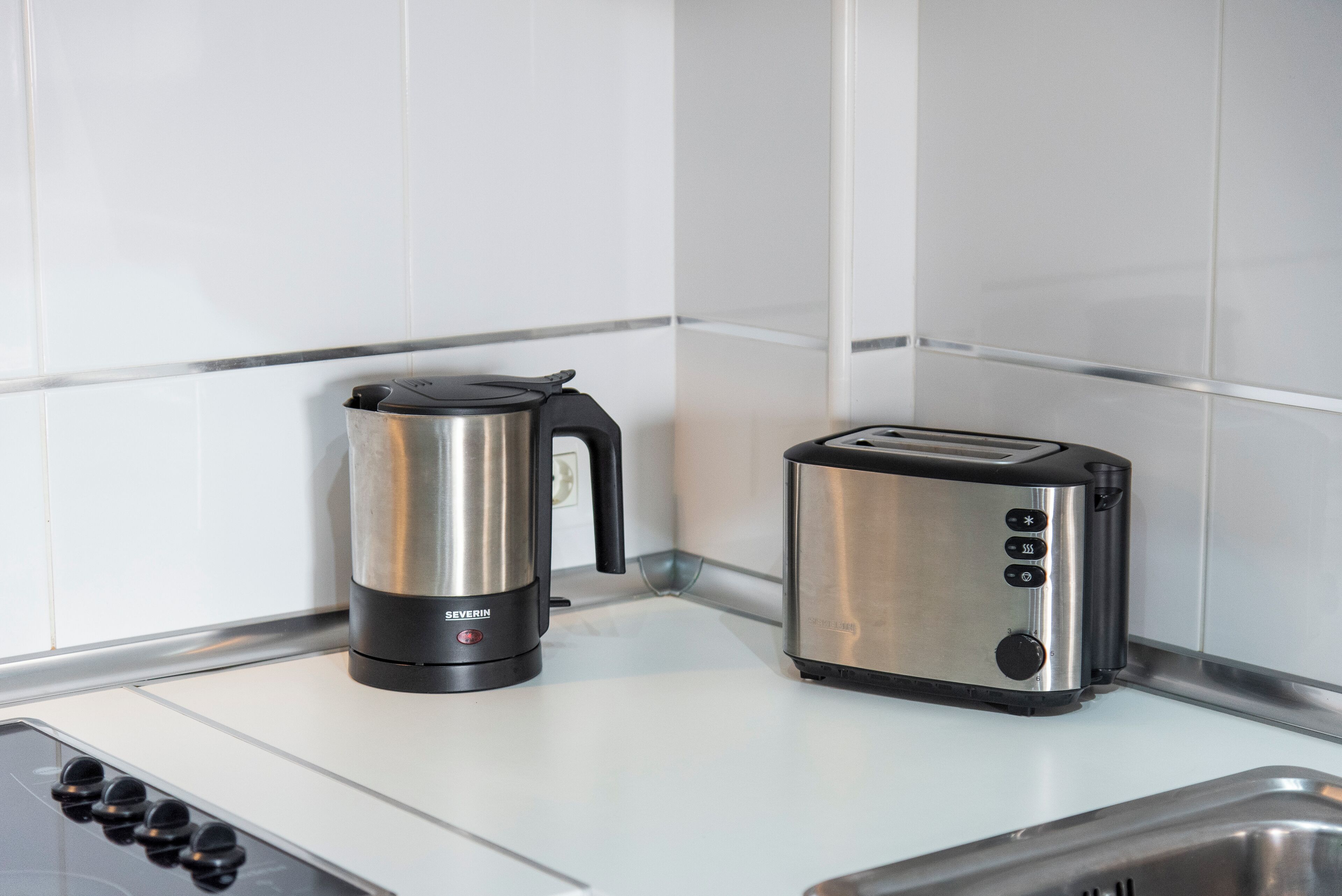 A modern kitchen with a coffee maker and a toaster on the counter.