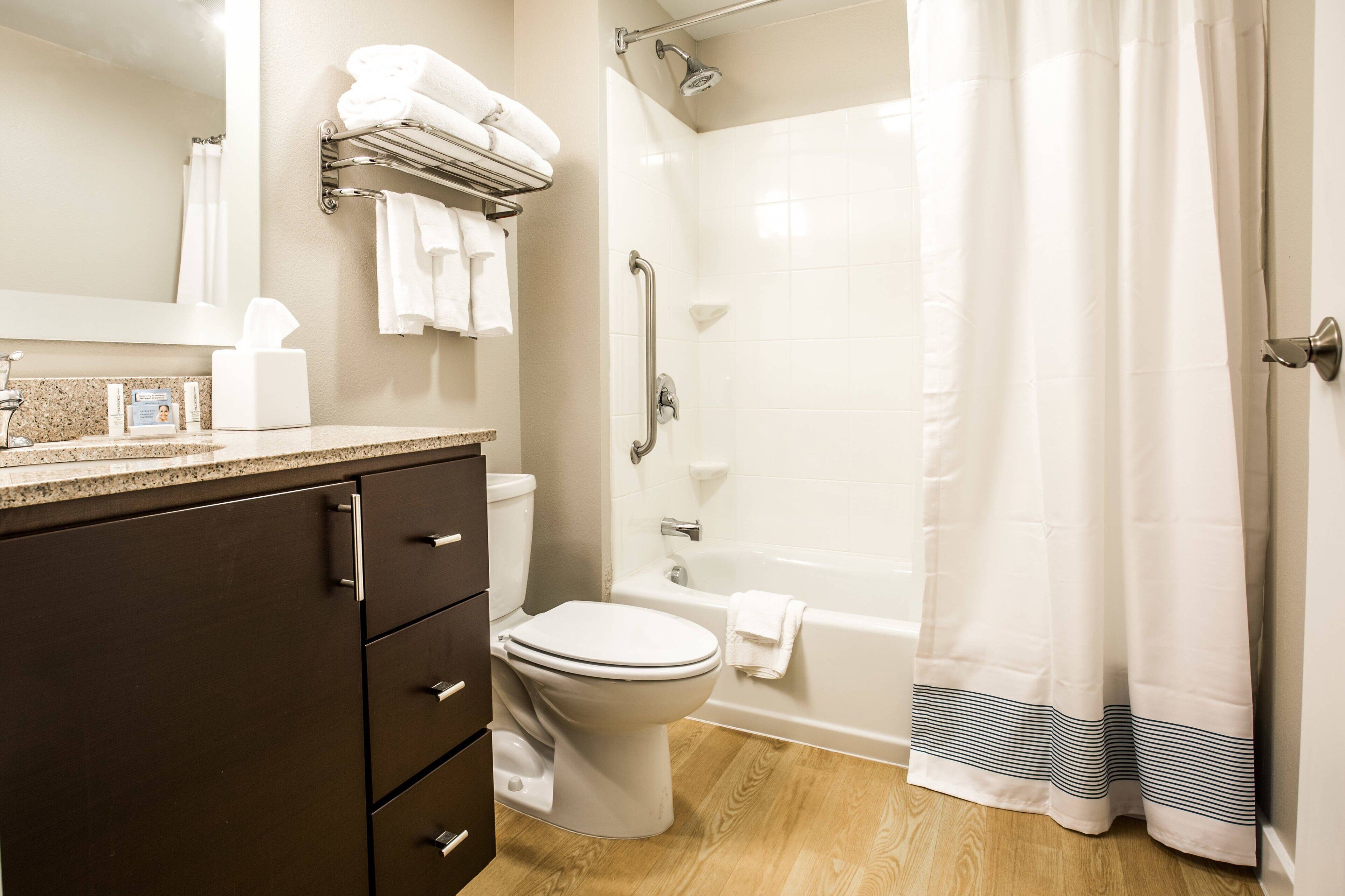 A modern bathroom with a toilet, sink, and bathtub.