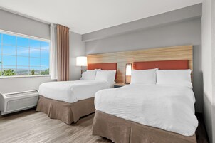 Habitación de hotel con dos camas, ventana con vistas y calefacción.