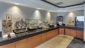 A modern breakfast bar with a variety of food options, including a coffee machine and a refrigerated display. - Fairfield Inn & Suites by Marriott Texarkana (Texarkana)