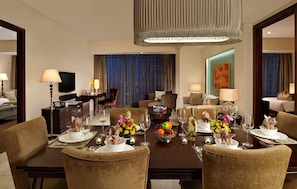 A hotel dining room with a large table set for a meal, surrounded by comfortable seating. - Joy Nostalg Hotel and Suites Manila Managed by The Ascott Limited (Pasig)