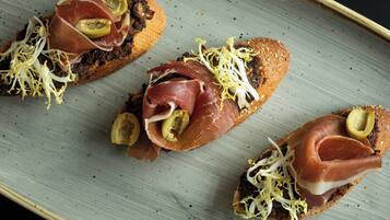 Tres sándwiches abiertos sobre un plato de cerámica.