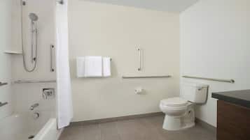 A bathroom with a bathtub, toilet, and shower.