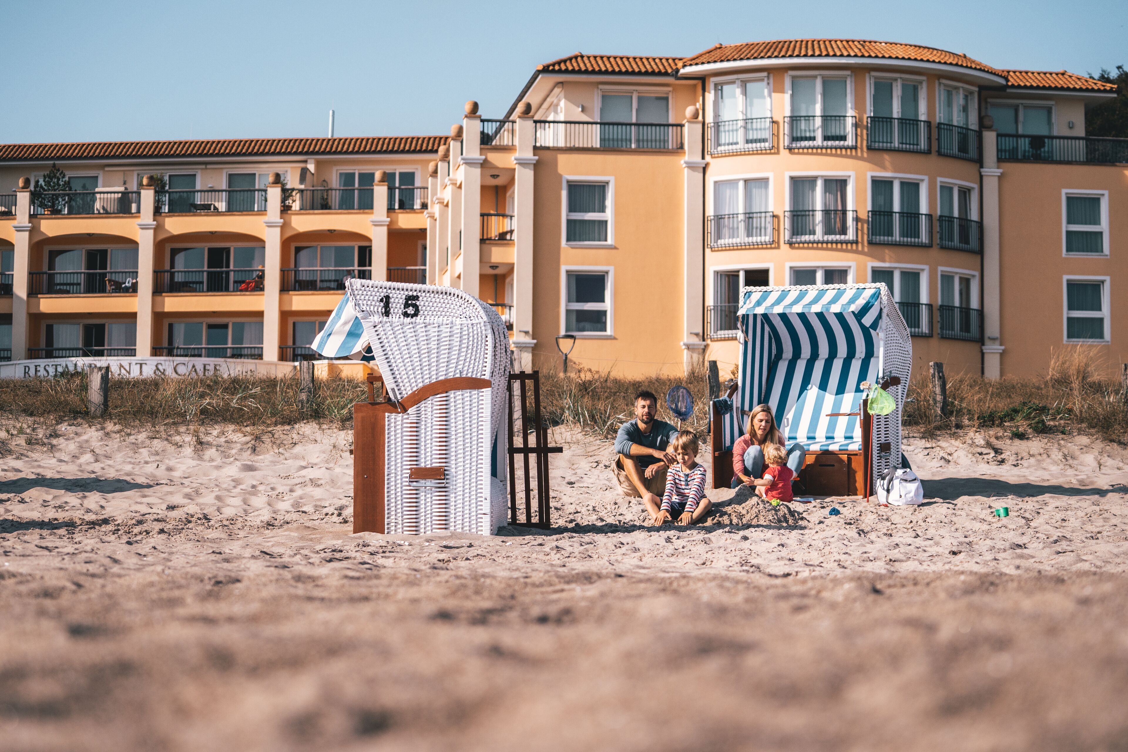 Un edificio frente a la playa con un letrero de restaurante y cafetería.