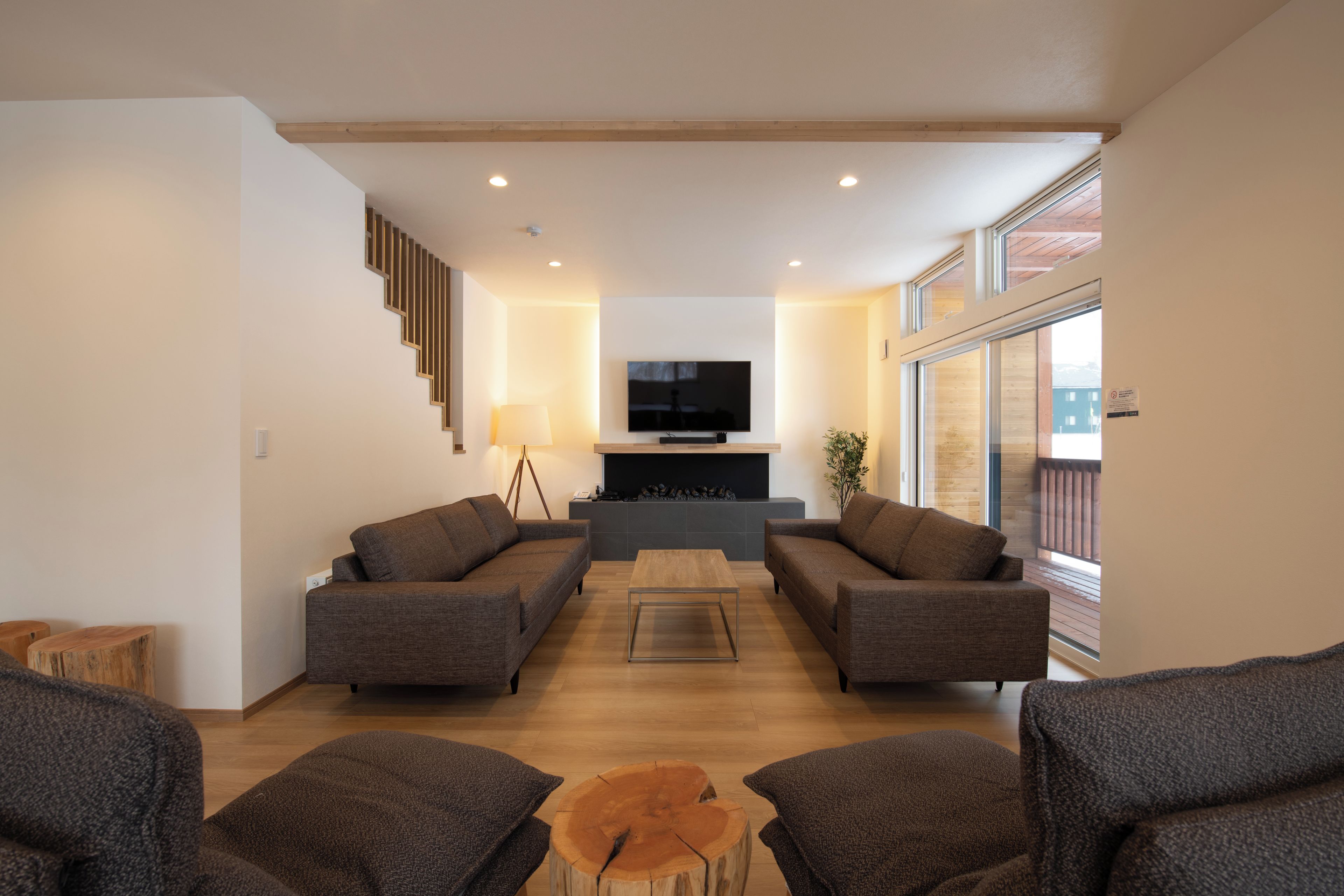 A modern living room with a sofa set, a coffee table, and a television.