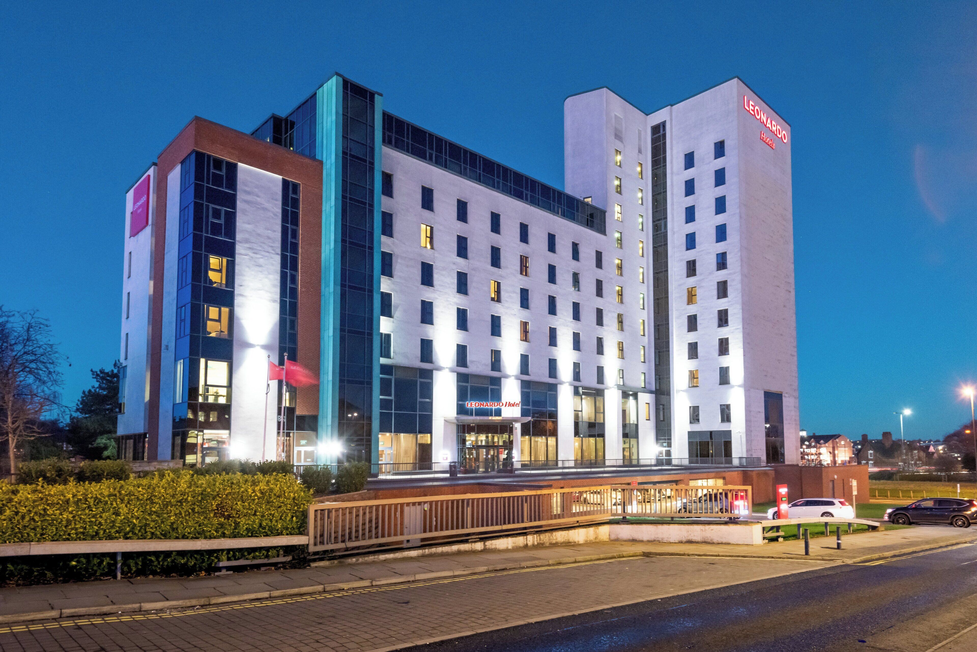 A modern hotel building with a prominent 'Leonardo Hotels' sign.