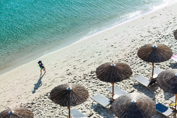 On the beach, sun-loungers, beach umbrellas, beach towels