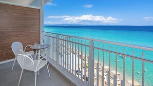 A balcony with a view of the ocean, white chairs, and a small table. - Ammon Zeus Luxury Beach Hotel (Kassandra)