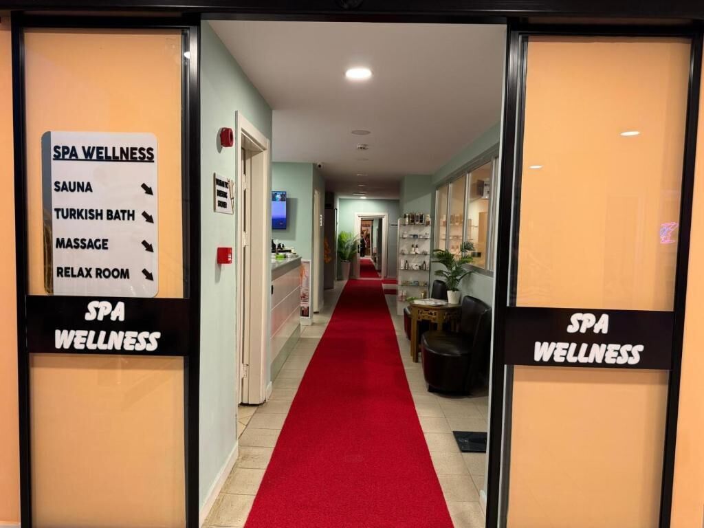 A spa wellness area with a red carpet leading to a reception desk.