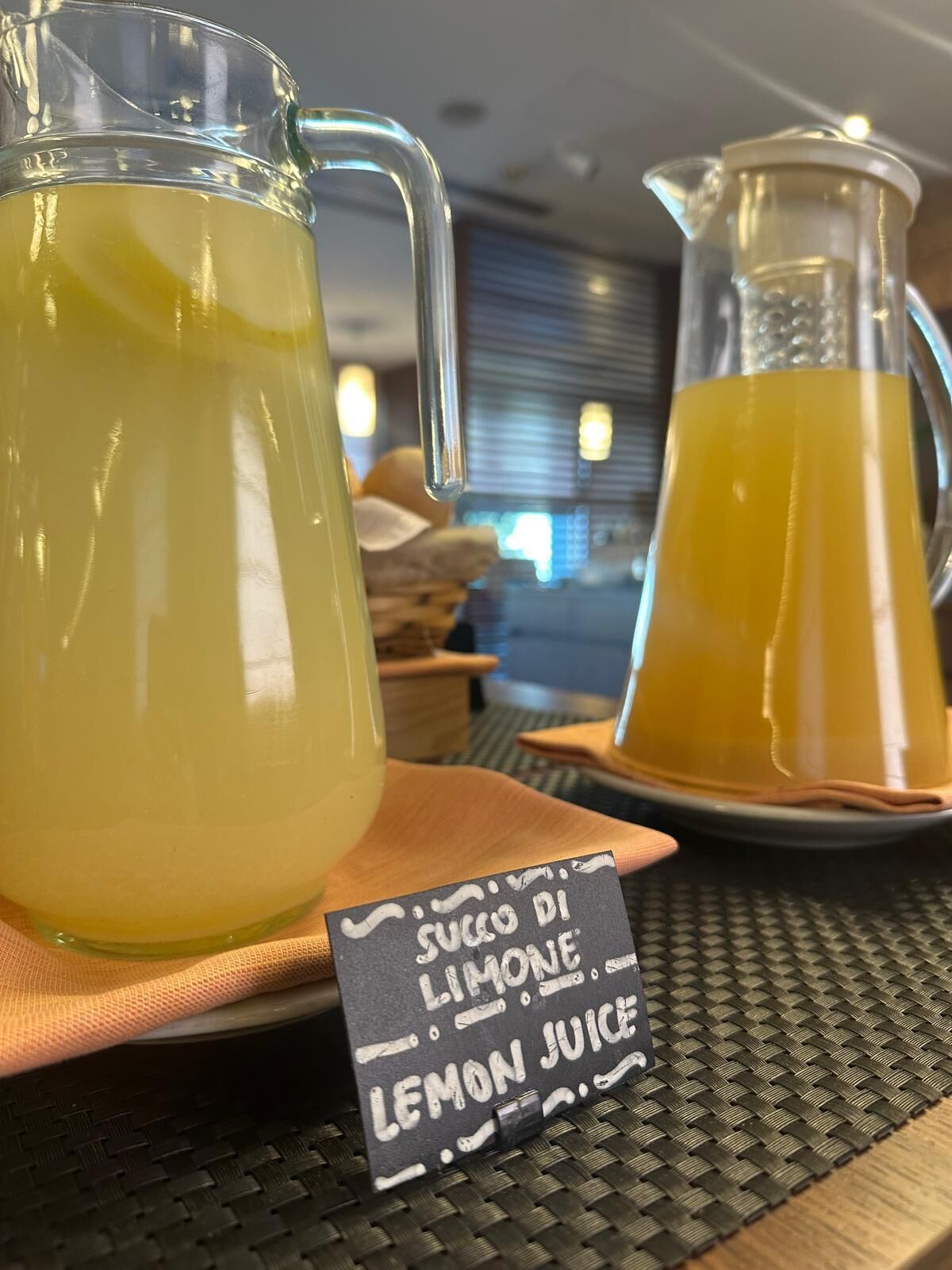 Due caraffe di succo di limone su un tavolo con un cartello.