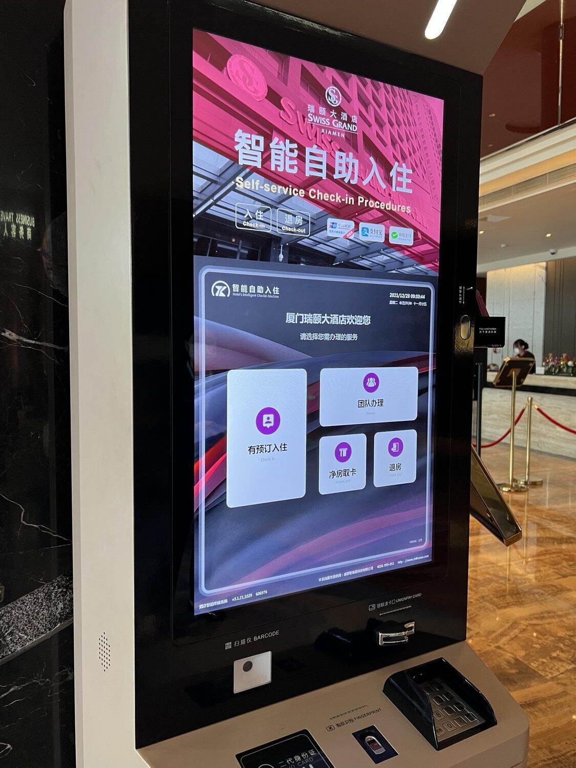 A digital self-service check-in kiosk at a hotel with options for check-in, check-out, and room service.