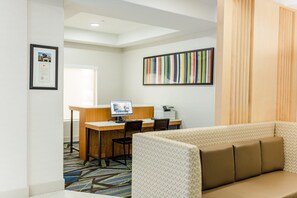 A modern office space with a desk, computer, and chairs. There is a framed certificate on the wall and a colorful striped artwork. - Holiday Inn Express Andalusia by IHG (Andalusia)