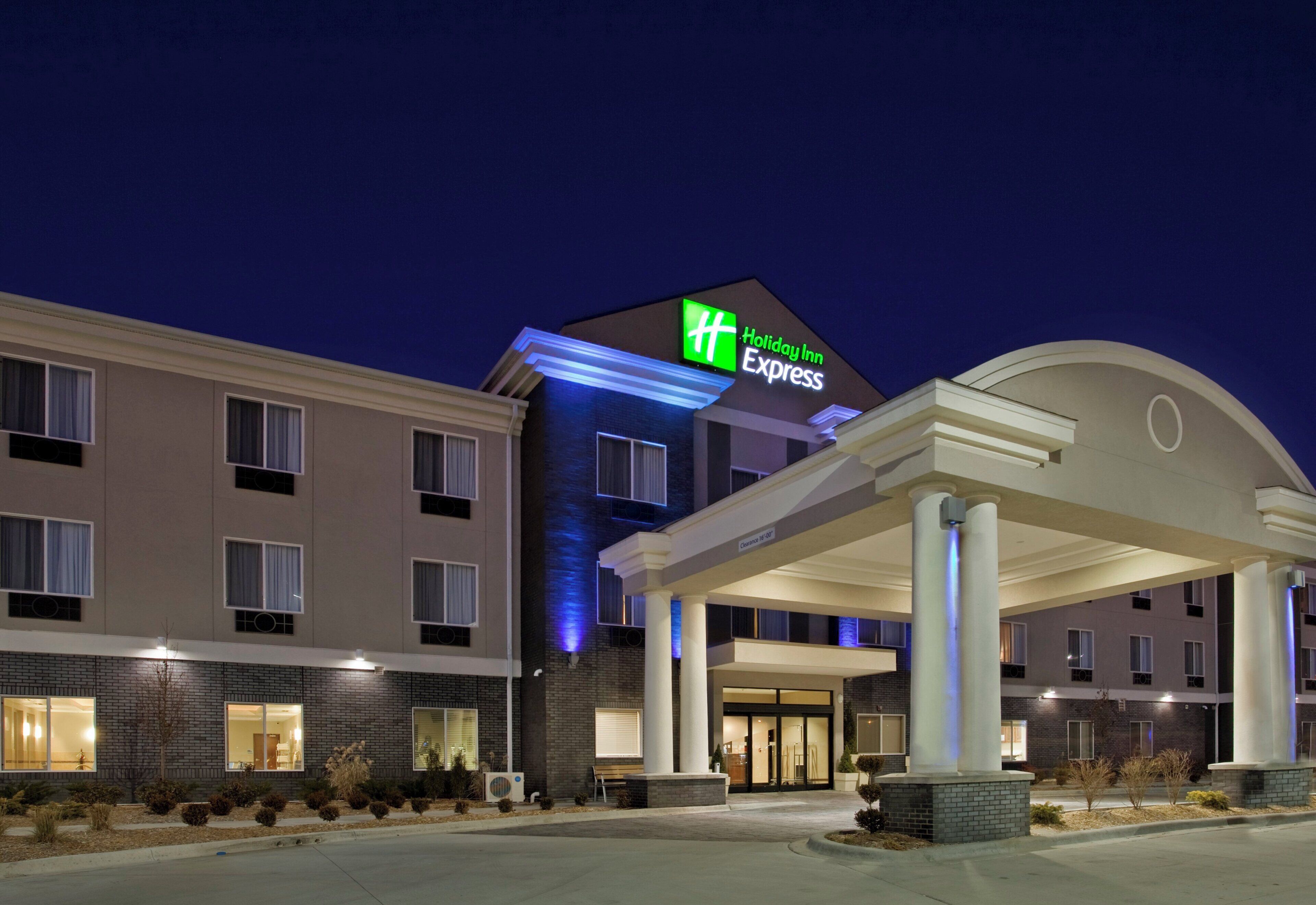 A Holiday Inn Express hotel with a modern facade, large windows, and a prominent entrance.