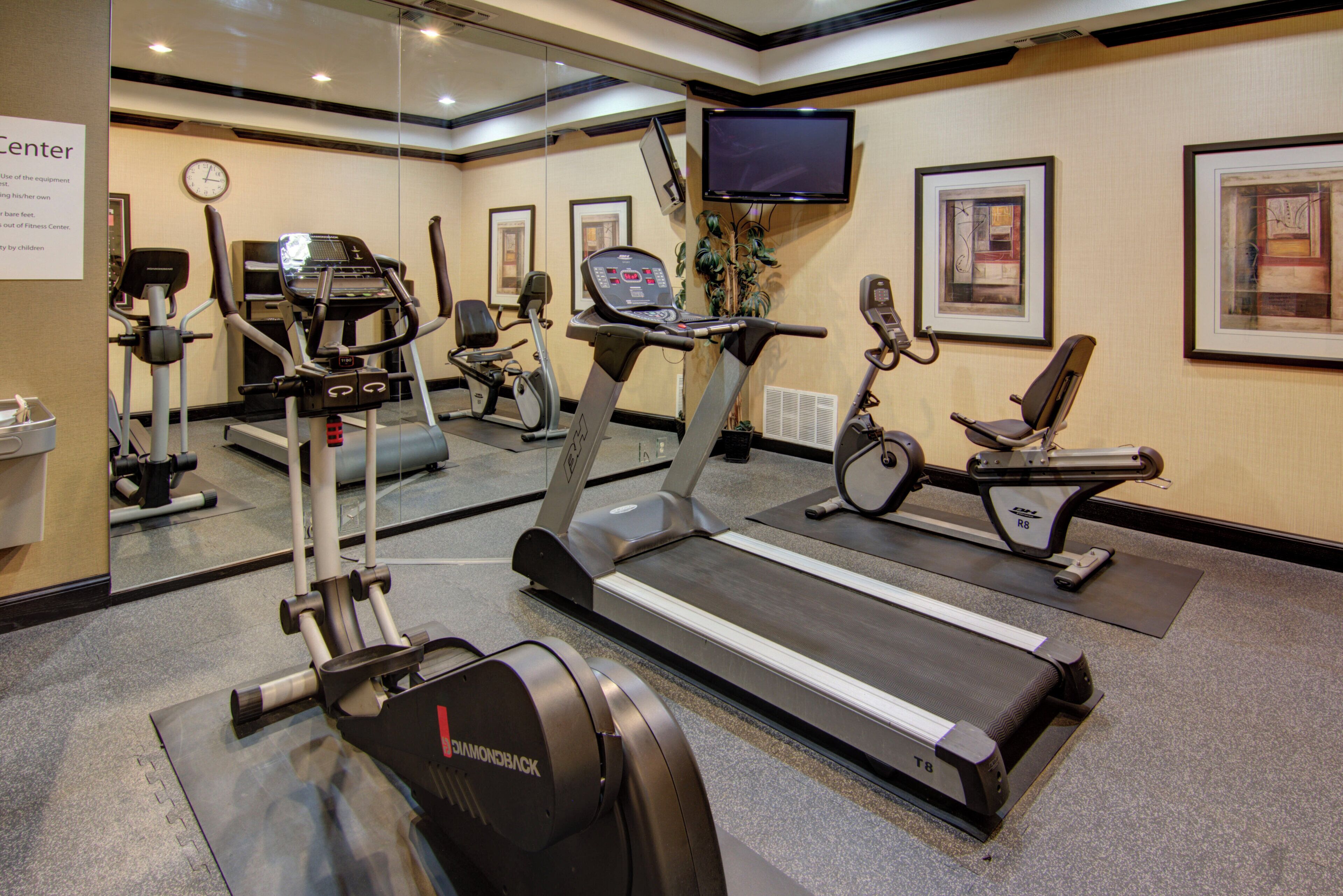 A fitness center with treadmills, stationary bikes, and exercise equipment.