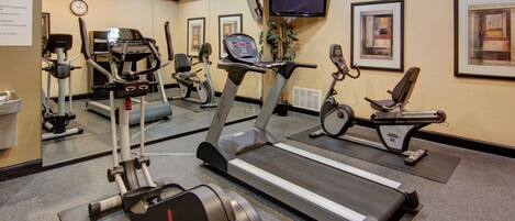 A fitness center with treadmills, stationary bikes, and exercise equipment.