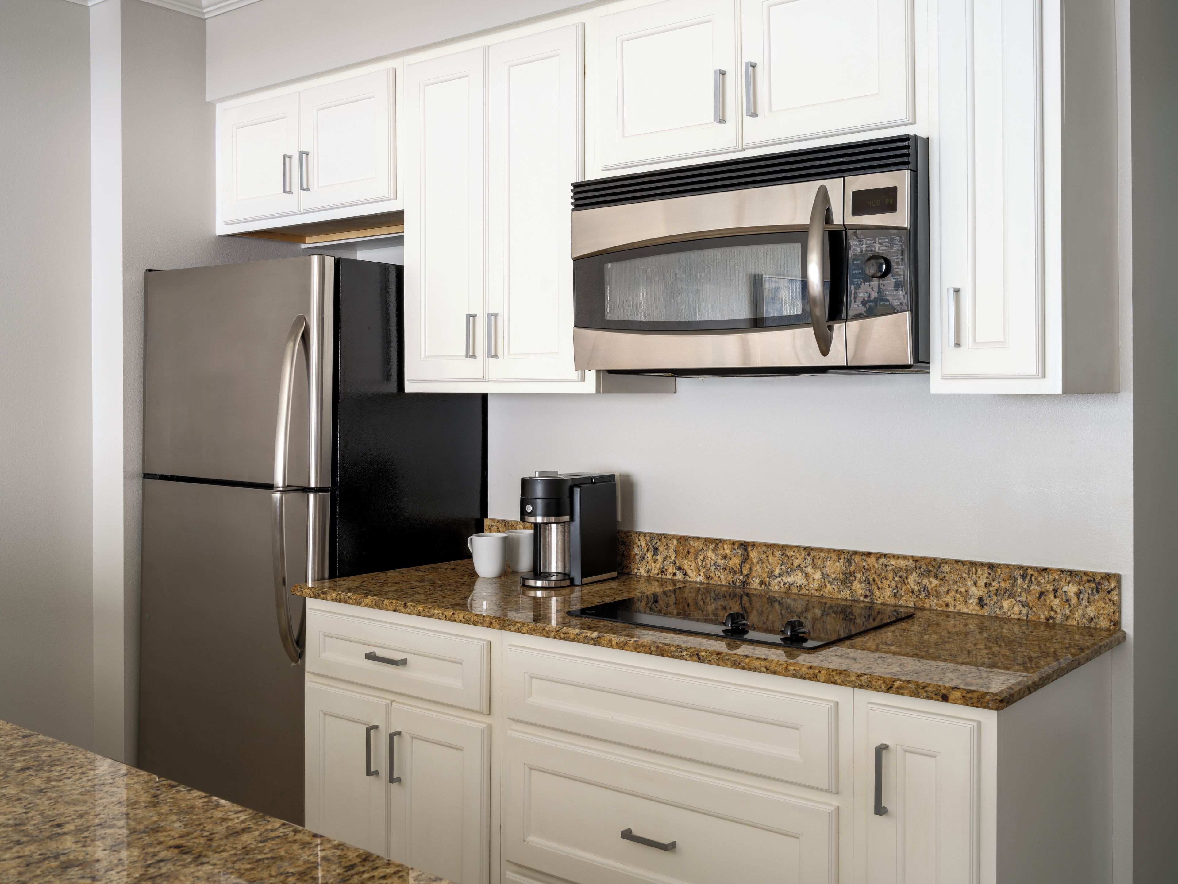 microwave, coffee/tea maker, toaster, cookware/dishes/utensils