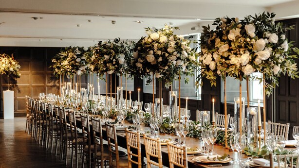 A long banquet table with chairs, candles, and floral arrangements. - Kimpton Blythswood Hotel & Spa by IHG (Glasgow)