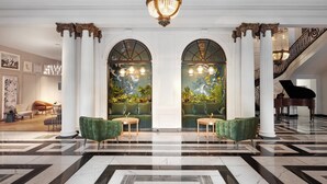 A grand lobby with marble flooring, green armchairs, a grand piano, and a staircase. - Kimpton Blythswood Hotel & Spa by IHG (Glasgow)