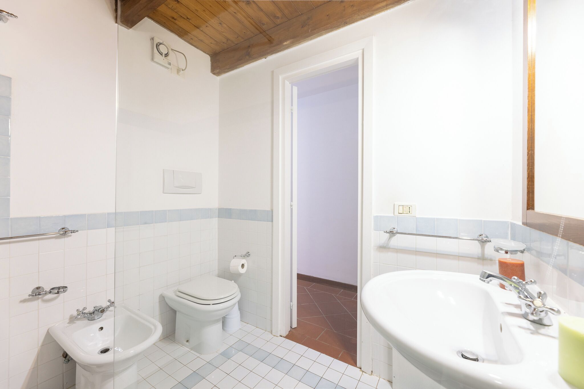 A bathroom with a toilet, bidet, and sink.