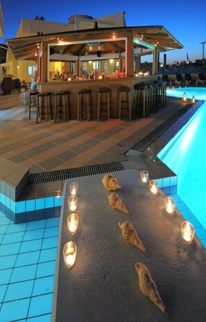 An outdoor bar area with a poolside seating arrangement and a bar counter. - Filia Hotel Resort (Hersonissos)