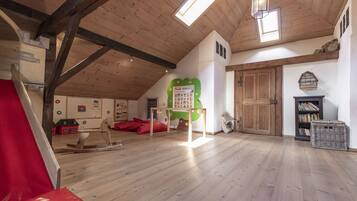 Enjoy a family-friendly stay with a fireplace, bookshelf, and play areas featuring a slide and rocking horse.