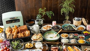 A table with various dishes, including bread, salads, and meats, suggesting a buffet-style meal. - the b ikebukuro (Tokyo)