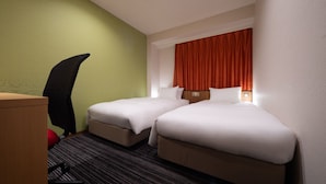 A hotel room with two beds, a desk, and a chair. - the b ikebukuro (Tokyo)