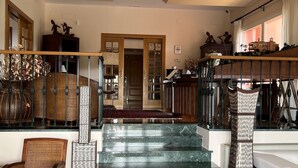 A spacious interior with a grand staircase, a high ceiling, and a view of the outside. - The Marbella Heights Boutique Hotel (Marbella)