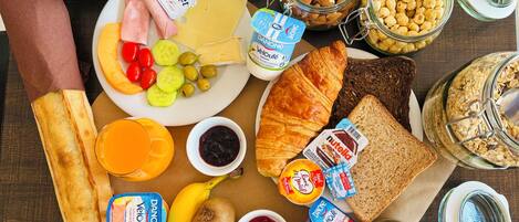 A breakfast spread with various food items and condiments.