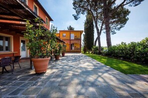 Stroll through the beautifully landscaped courtyard, lined with lush plants and a serene lawn, to the entrance of this charming building.