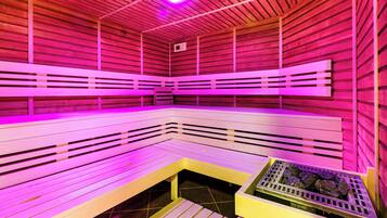 A sauna with wooden benches and a tiled floor.