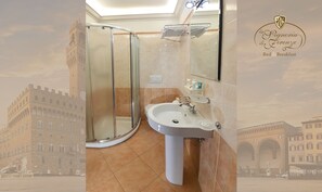 A bathroom with a glass shower enclosure, a sink, and a mirror. - La Signoria di Firenze (Florence)