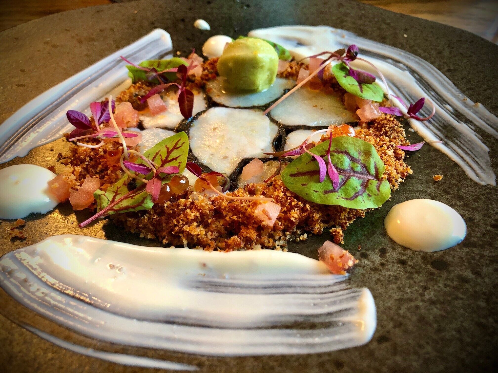A dish with various toppings and garnishes on a plate.