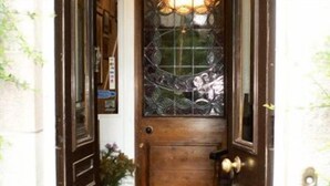 A wooden door with a glass panel and a brass doorknob. - Greystones B&B (Kingussie)