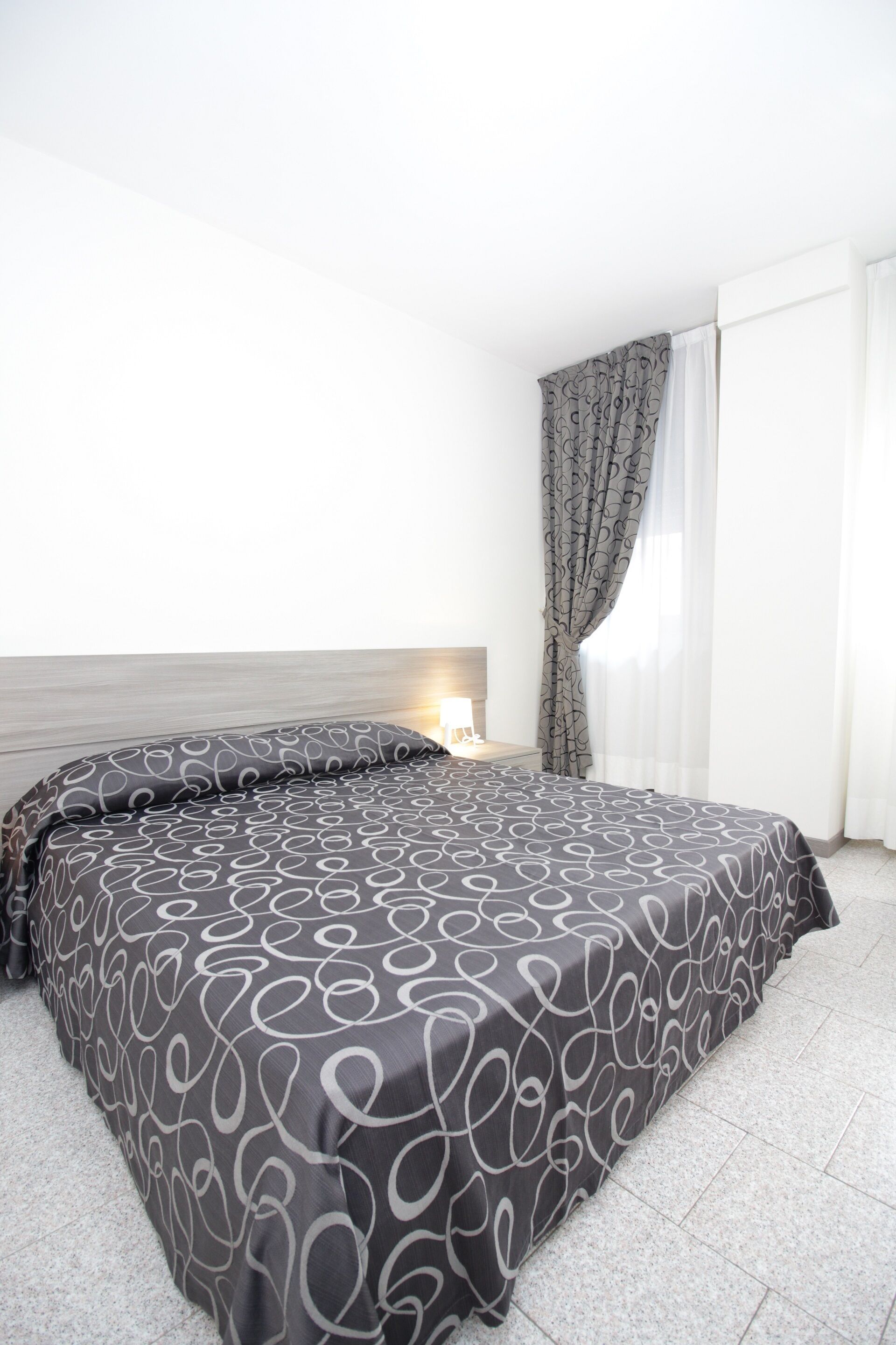 ميني بار وخزنة داخل الغرفة ومكتب وملاءات أسرّة