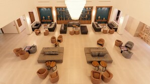 A spacious lobby with multiple seating areas, a large chandelier, and decorative wall panels. - Yadis Hammamet Club (Hammamet)